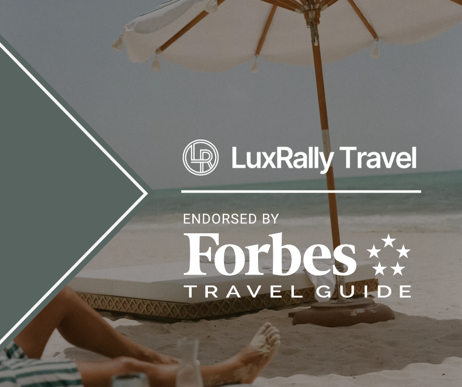 A woman on a beach, overlayed with the text, "LuxRally Travel. Endorsed by Forbes Travel Guide."